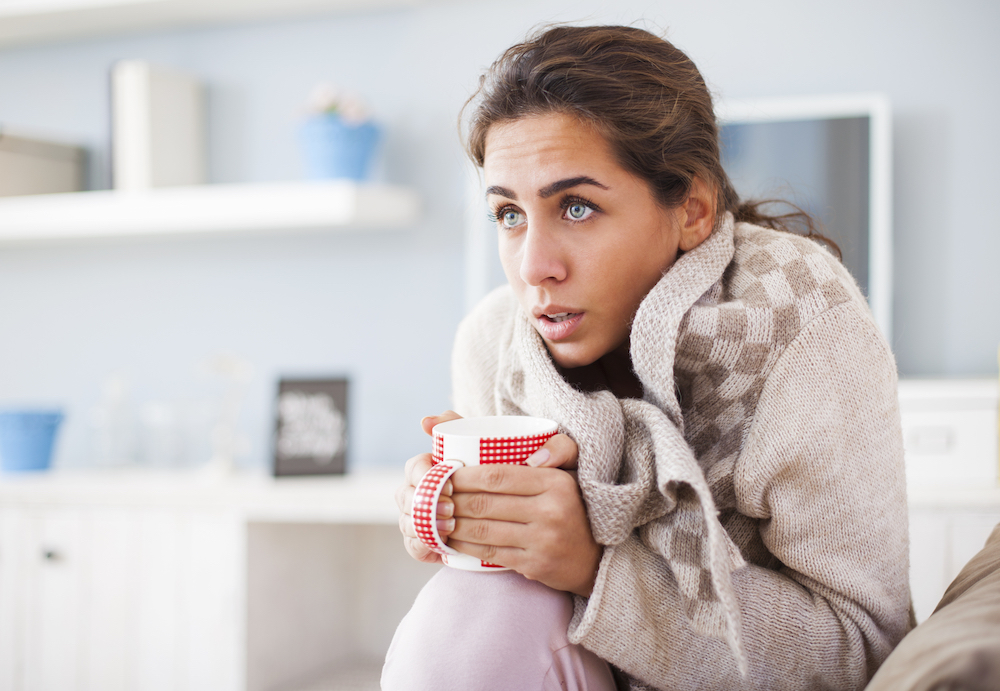 sick-young-caucasian-girl-coughing-while-lying-under-blanket-at-home