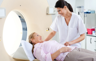 radiology tech looks at patient getting a ct scan
