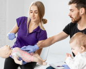 People learning about Infant CPR with a doll