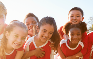 Kids avoiding sports injuries by staying safe in outdoors elementary school sports