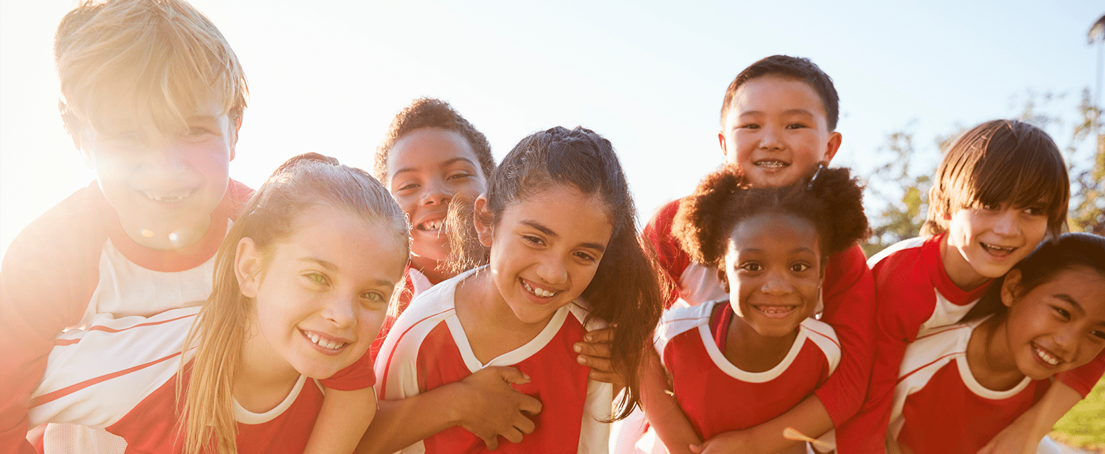 Kids avoiding sports injuries by staying safe in outdoors elementary school sports