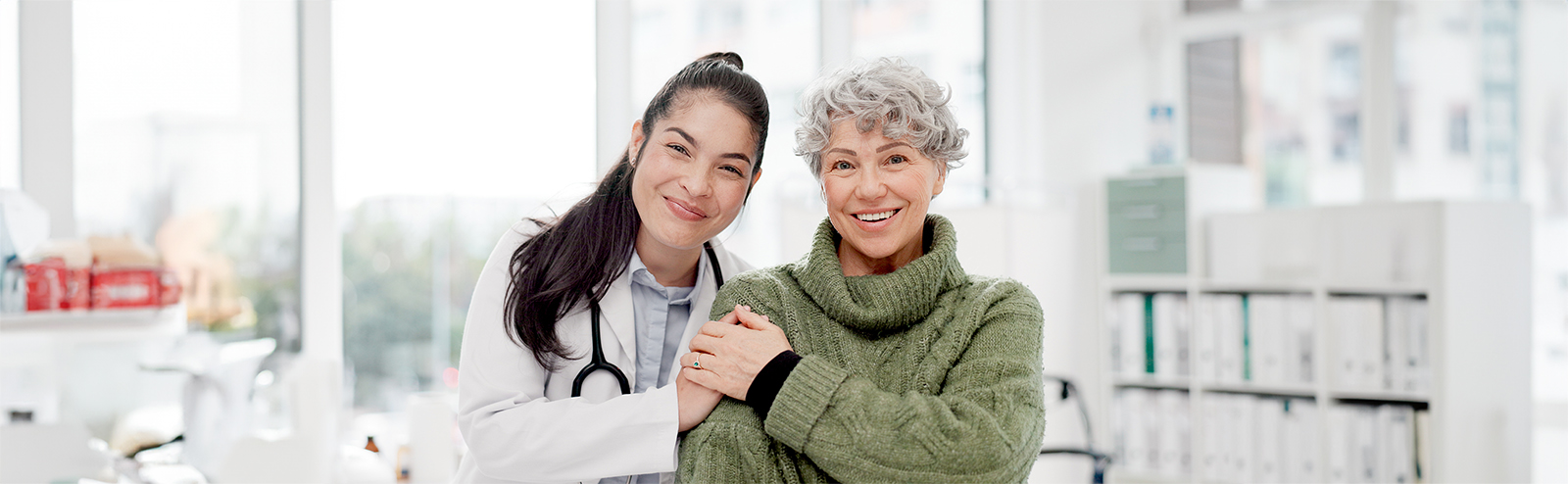 Happy female doctor discusses the benefits of kegel exercises with female patient.